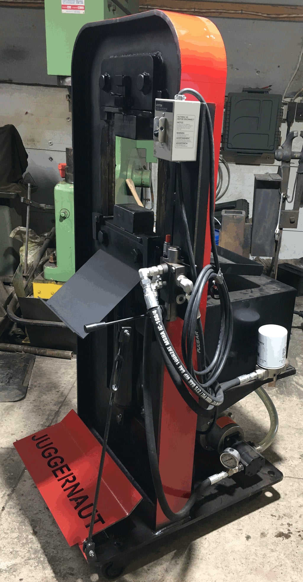 JUGGERNAUT 29T H-frame hydraulic forging press built in Ontario Canada — solid 1 inch plate steel construction with scale tray, hydraulic lines, and JUGGERNAUT nameplate