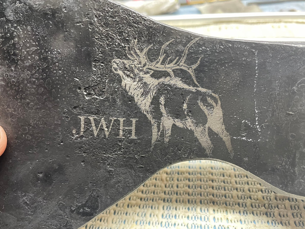 Custom laser engraved elk artwork on Taiga Moose bushcraft axe head featuring intricate wildlife detailing