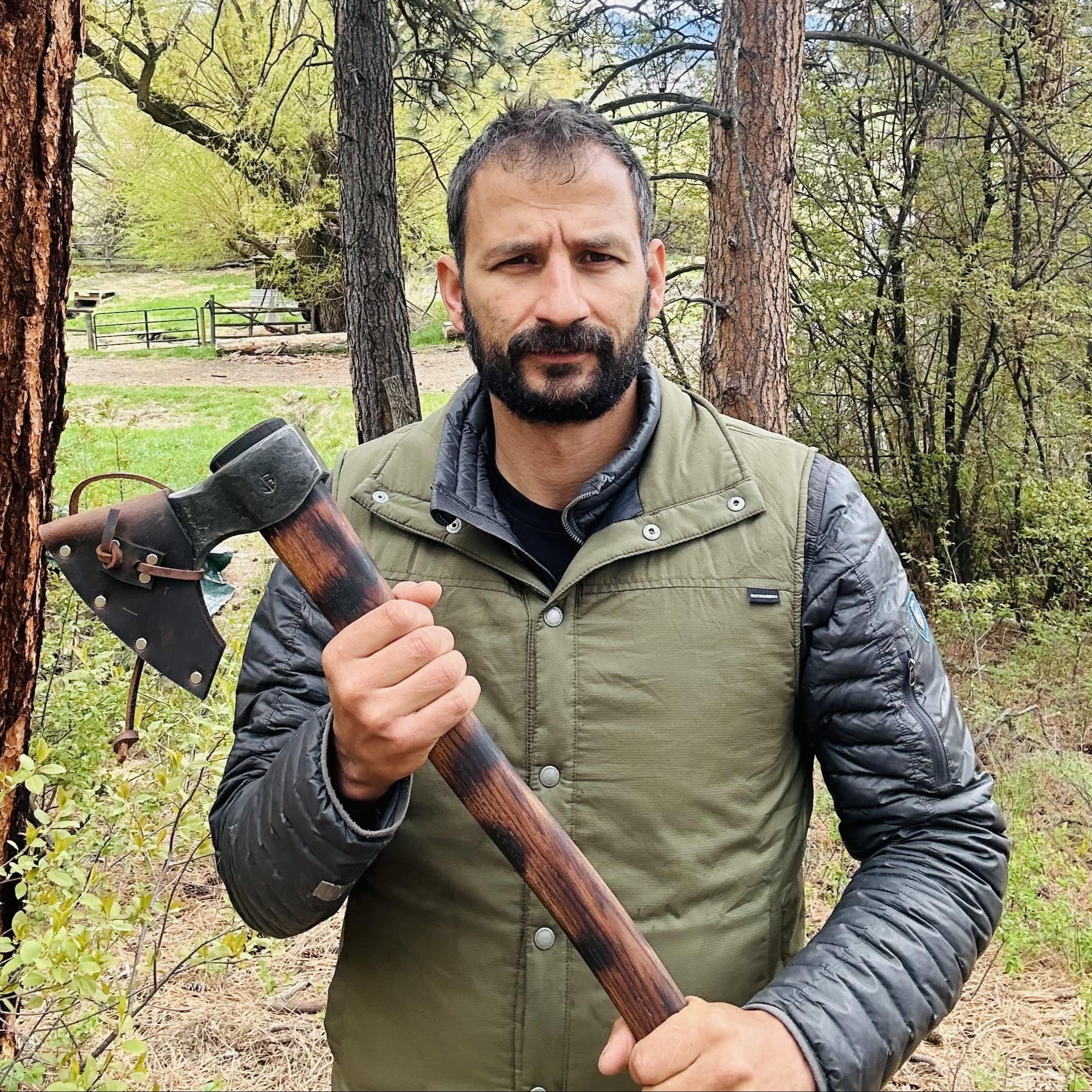 Jordan Jonas with a Taiga "Wolverine" bushcraft axe designed for extreme wilderness survival with Evenki-inspired features
