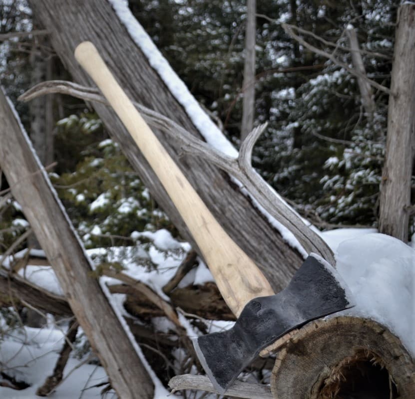 Double bit axe snow covered logs wood handle winter logging Canada Broad River Forge