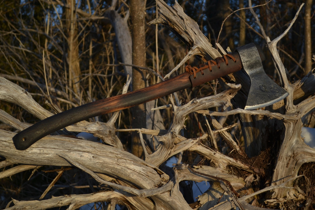 Taiga Moose survival axe with premium hickory handle displayed among natural wood and brush