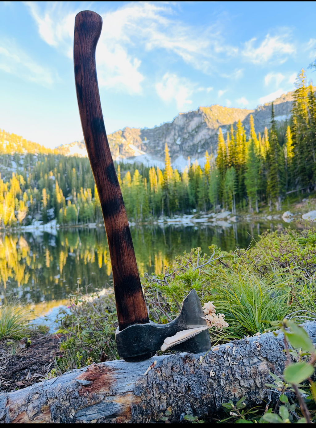 taiga wolverine axe set in a log for makng feathers to start a fire