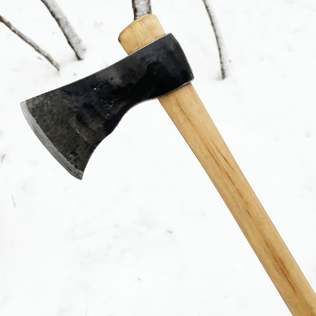 traditional hand-forged axe with natural hickory handle