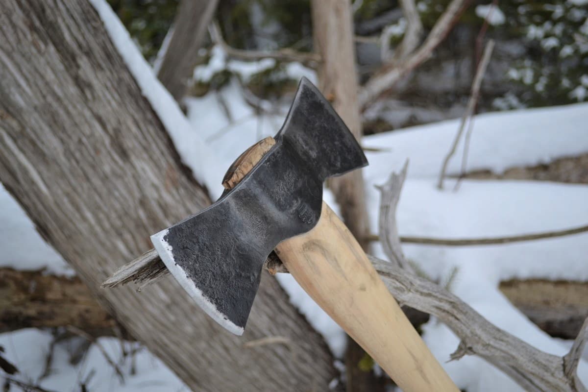Double bit axe embedded snowy tree wood handle forged steel Canada Broad River Forge