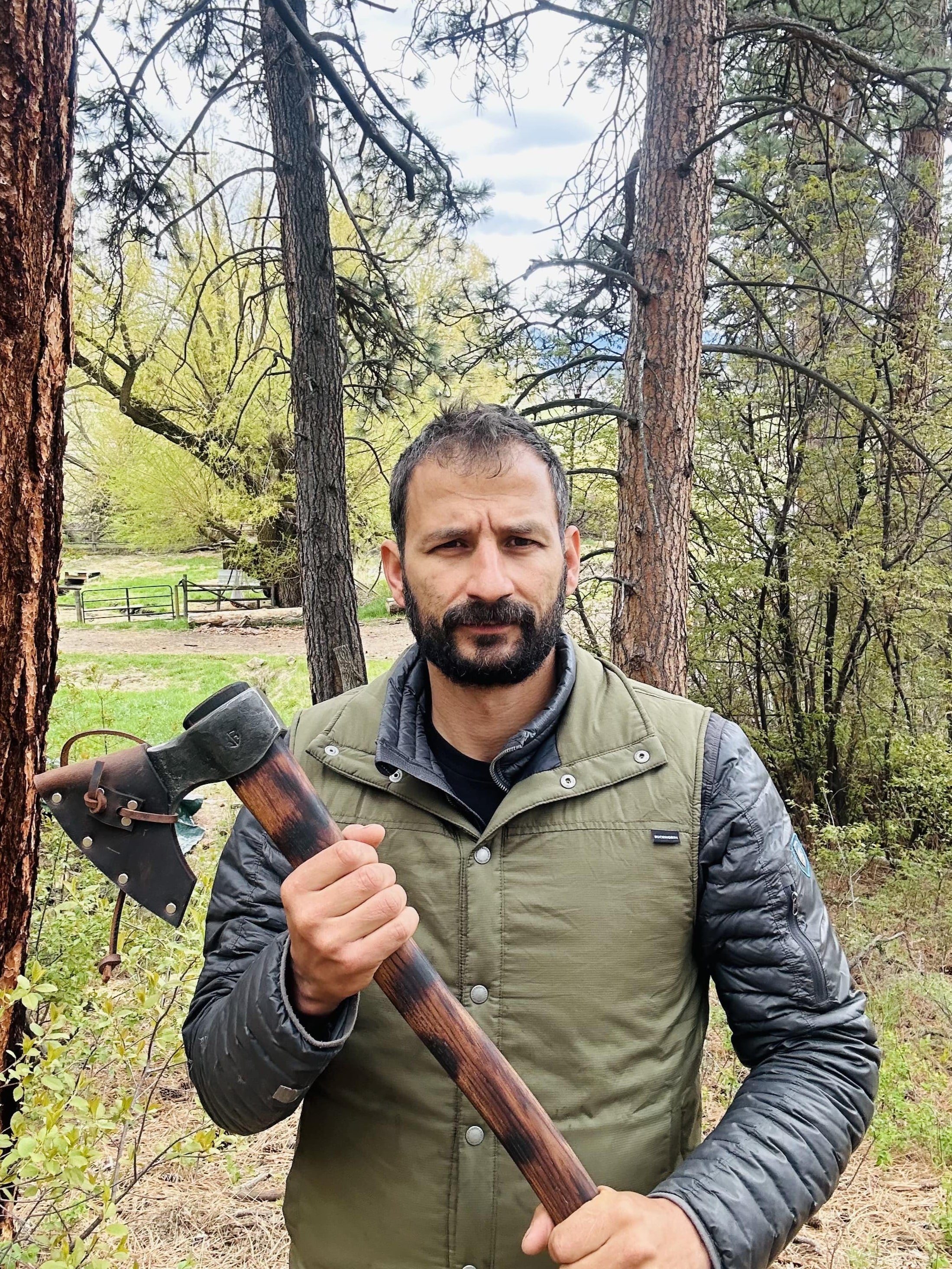 Jordan Jonas with a Taiga "Wolverine" bushcraft axe designed for extreme wilderness survival with Evenki-inspired features
